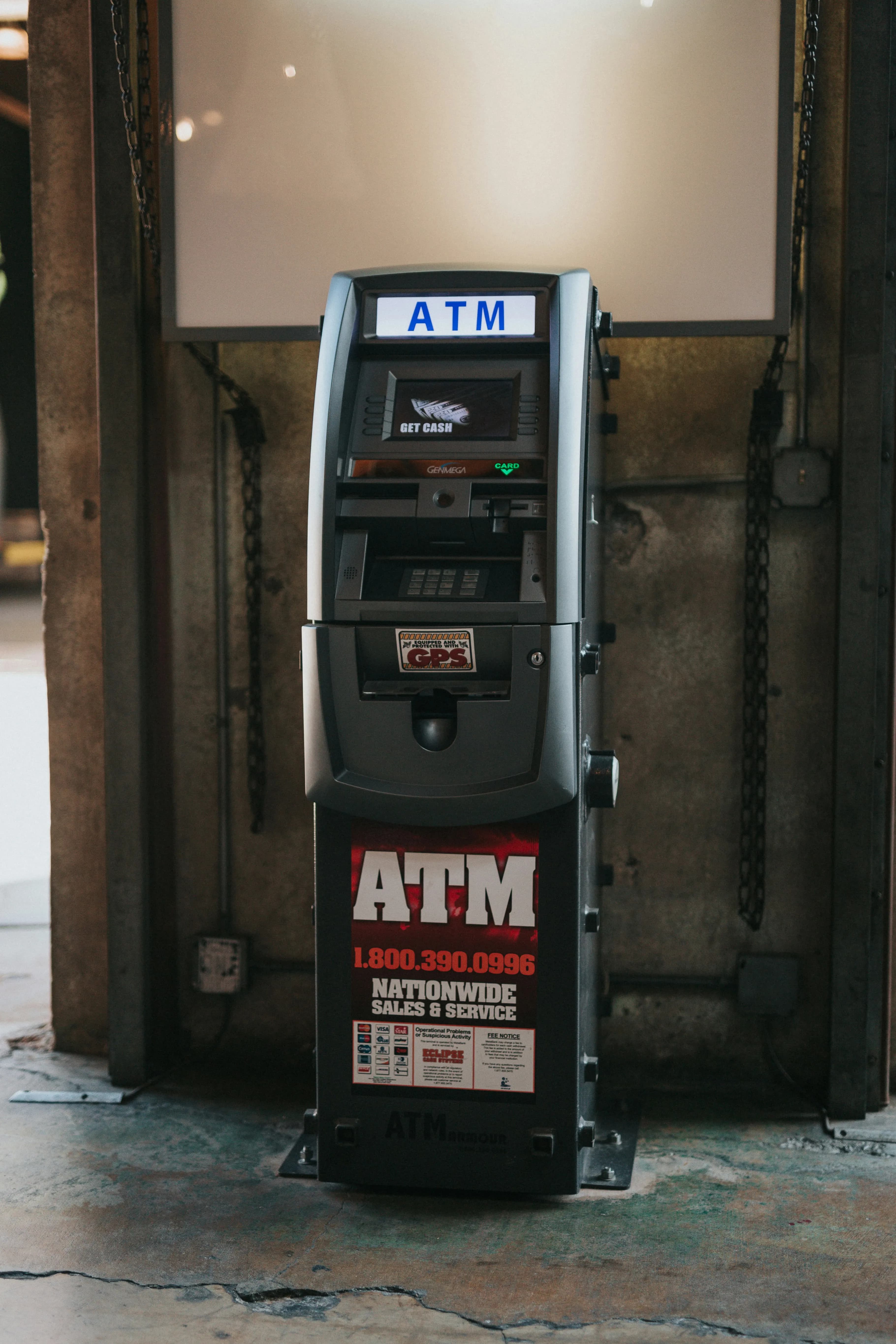 A free-standing ATM with the screen and keypad on top and a heavy cabinet below